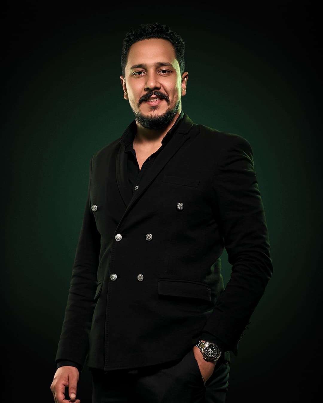 Mostafa Ahmed — Marketing Travel Consultant, wearing a tailored black double-breasted blazer
